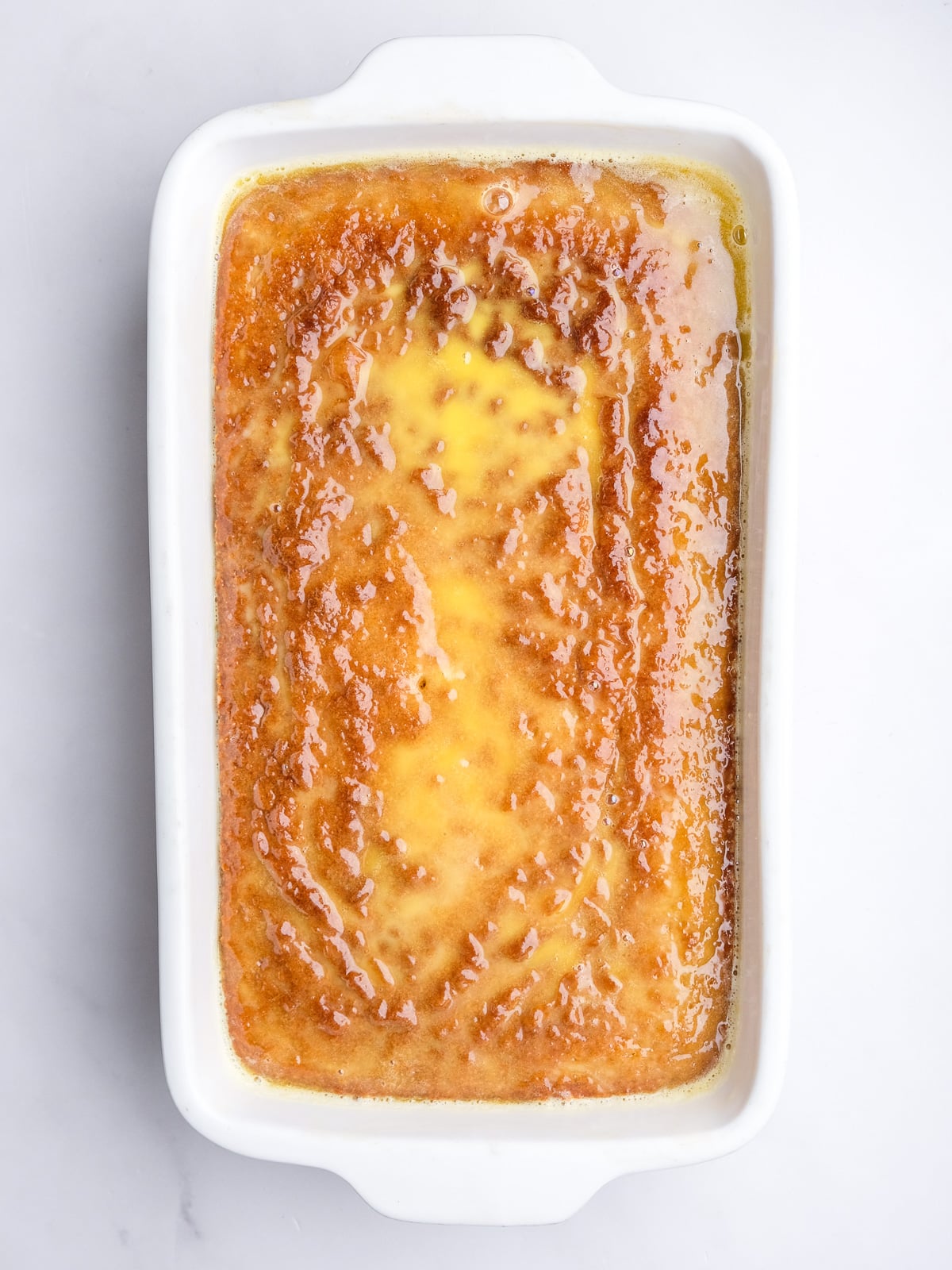 Image shows step 6 of how to make the malva pudding layer of this desert.