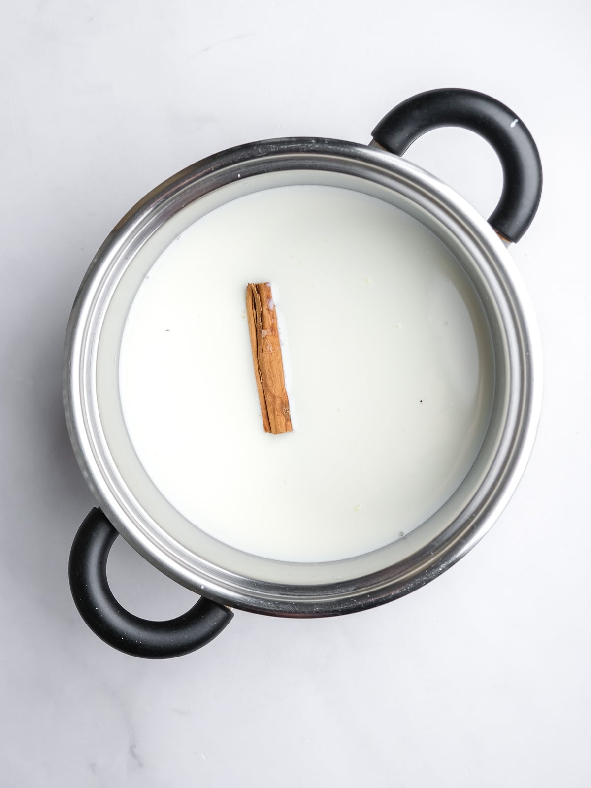 Image shows step 1 of how to make the milk tart layer of this desert.