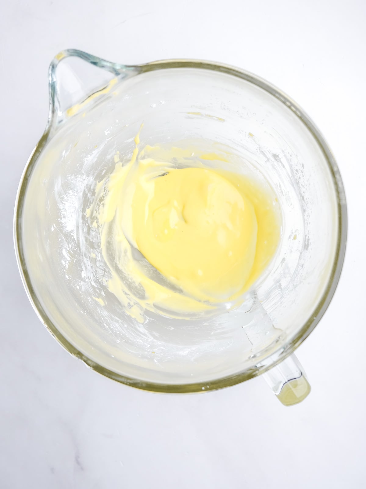 Image shows step 2 of how to make the milk tart layer of this desert.