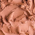 Whipped ganache frosting shown swirled over a flat surface.