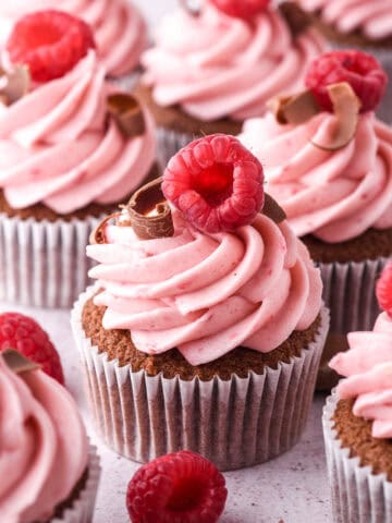 Raspberry Chocolate Cupcakes shown on a kitchen counter.