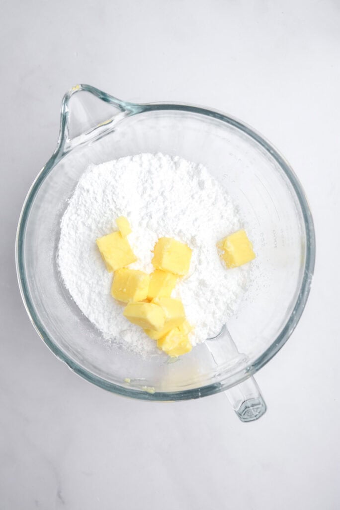 Image showing beginning of step one, the butter and icing sugar in a mixing bowl.