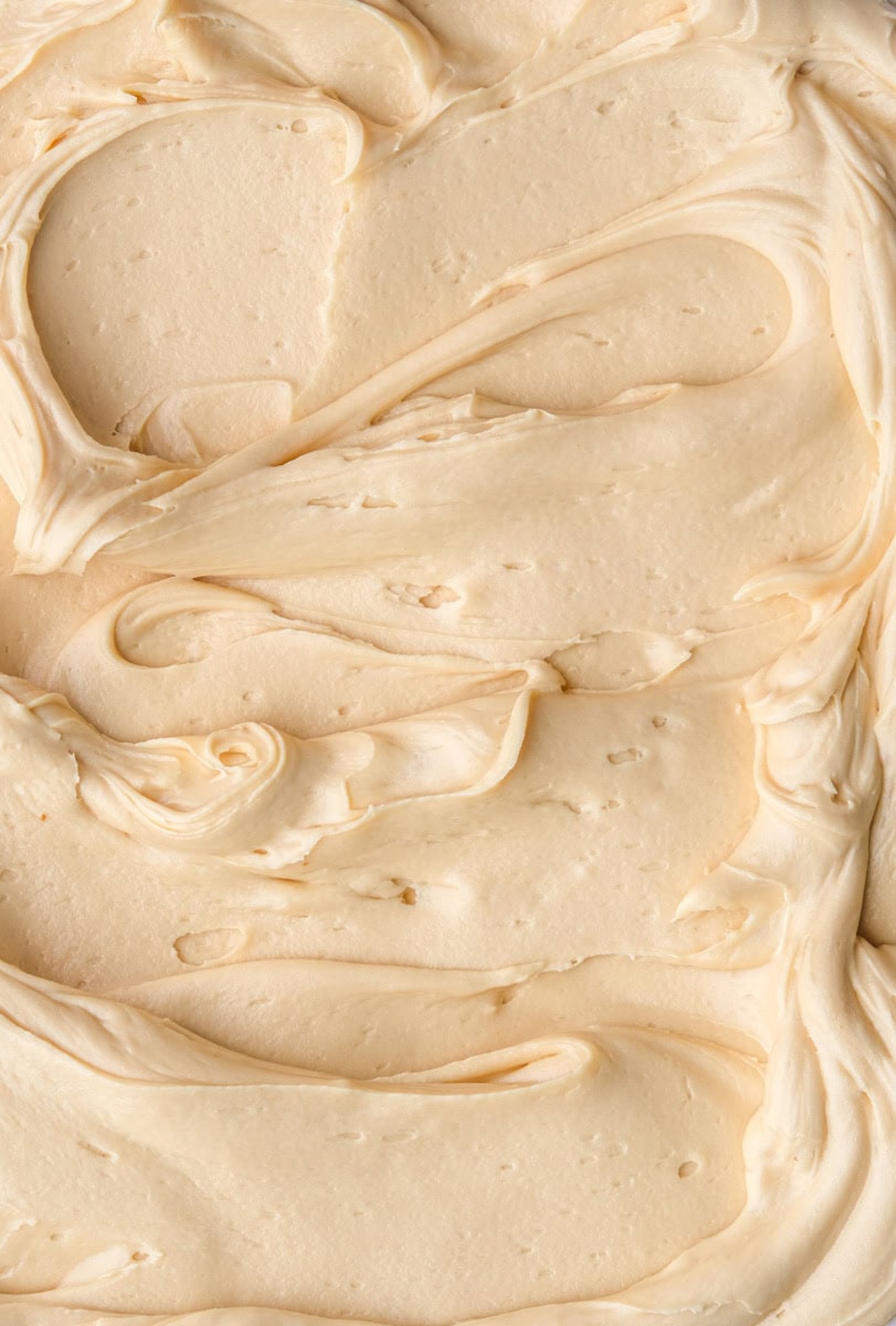 Image showing the frosting up close swirled on a flat surface, you can see the smooth texture of the frosting.