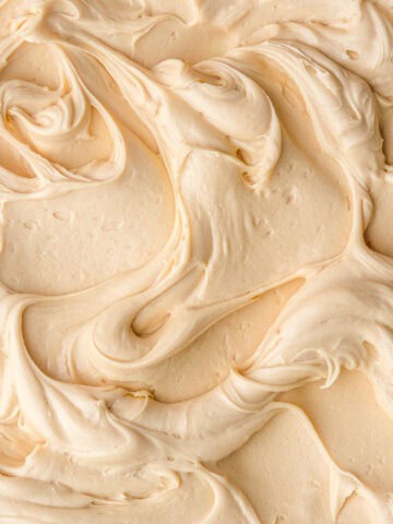 Dulce de Leche Frosting shown swirled on a flat surface.