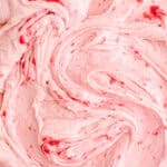 Raspberry Cream Cheese Frosting shown swirled, you can see the raspberry puree rippled through the frosting