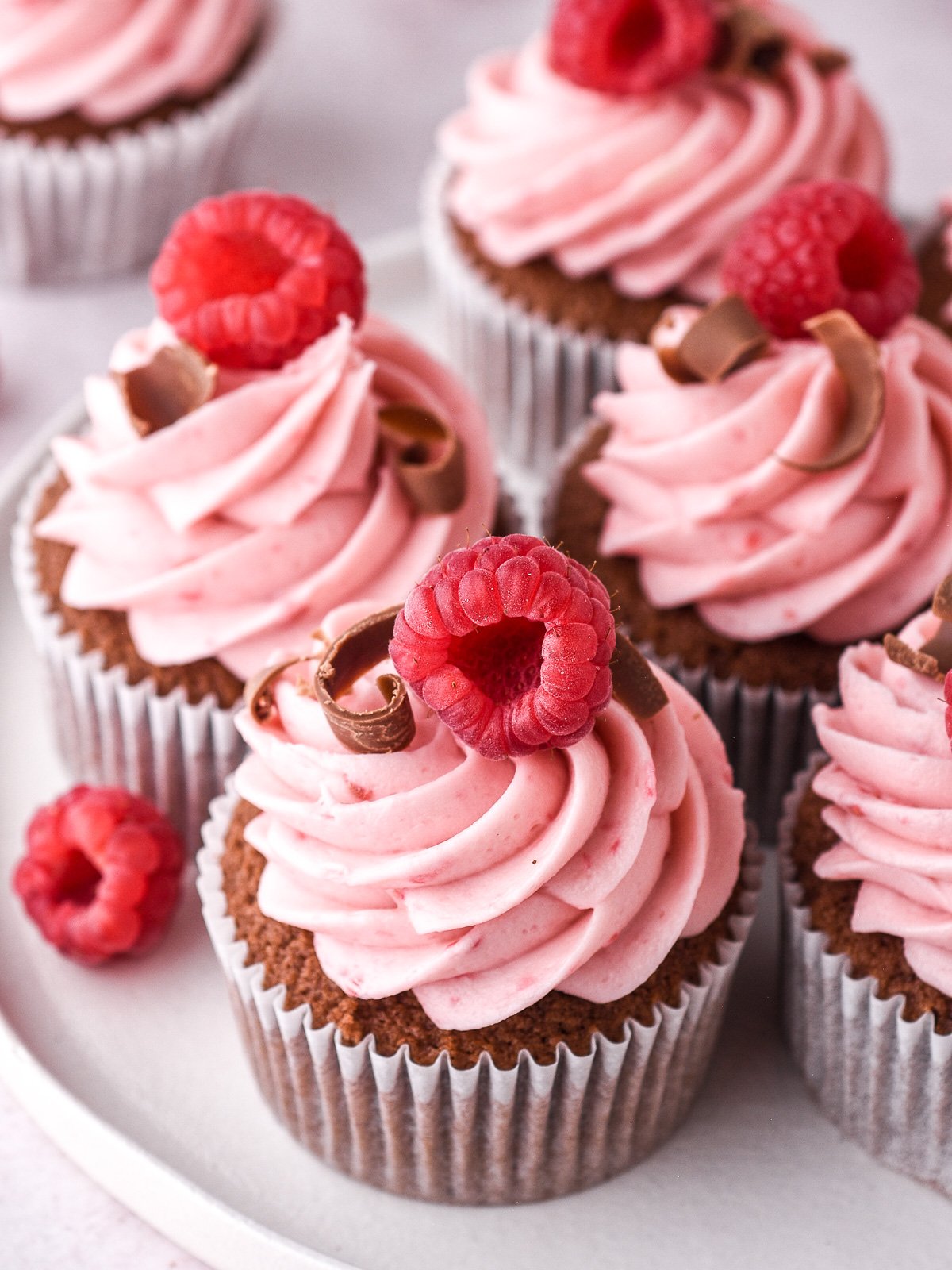 Image showing the frosting piped onto chocolate cupcakes.