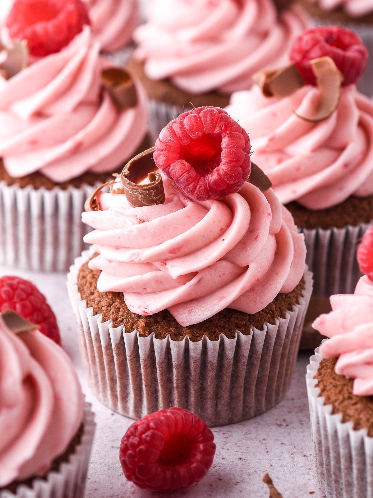 Close up image showing the chocolate raspberry cupcakes, you can see the swirl of frosting really well.