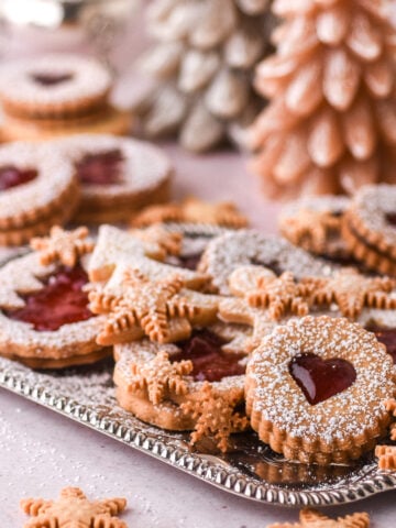Christmas Butter Cookies shown on a silver tray, they have been dusted with icing sugar.