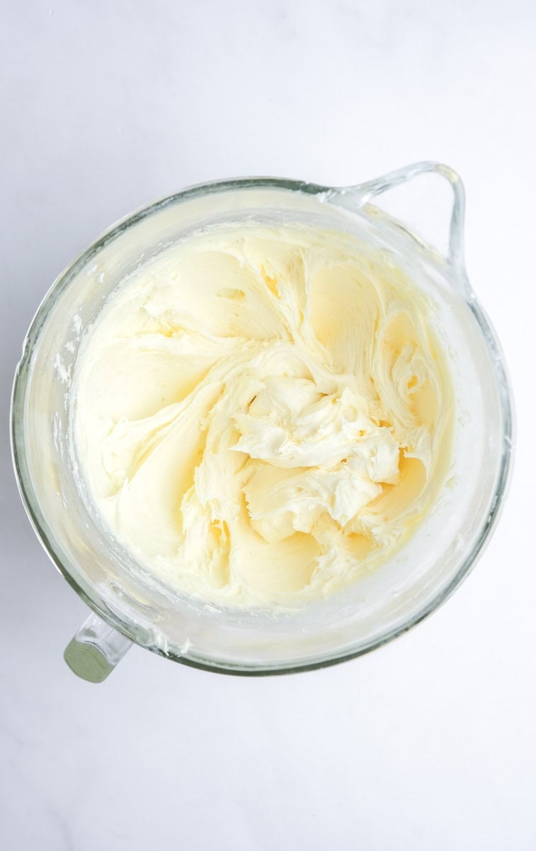 Image shows step 2 of how to make the raspberry cream cheese frosting.