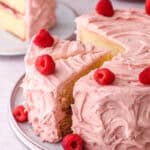 Image showing raspberry cake with a few slices cut.