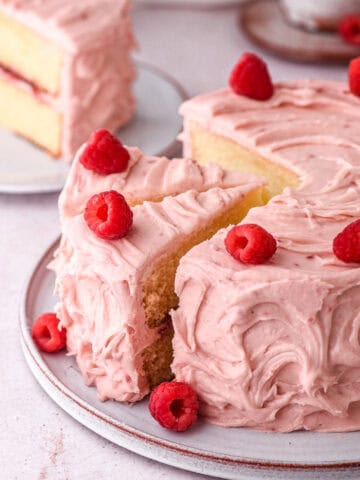Image showing raspberry cake with a few slices cut.
