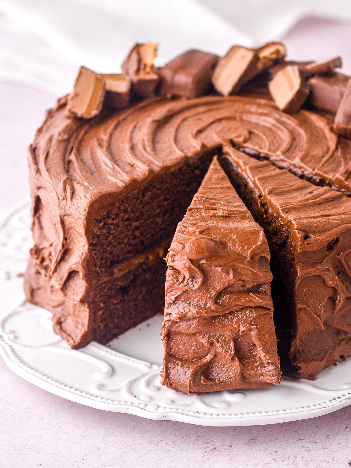 Image showing a bar one chocolate caramel cake with some slices cut.