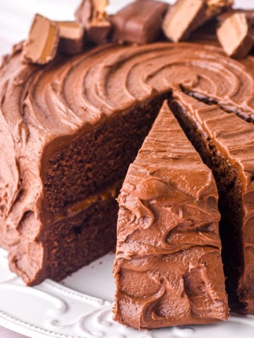 Bar One Cake shown whole with some slices cut.