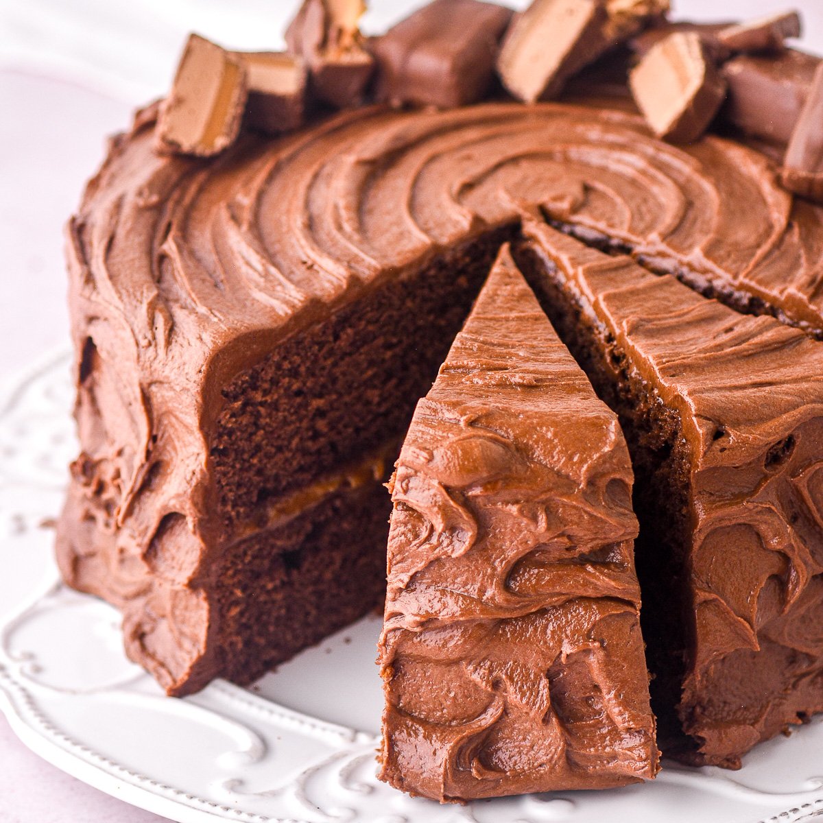 Bar One Cake shown whole with some slices cut.