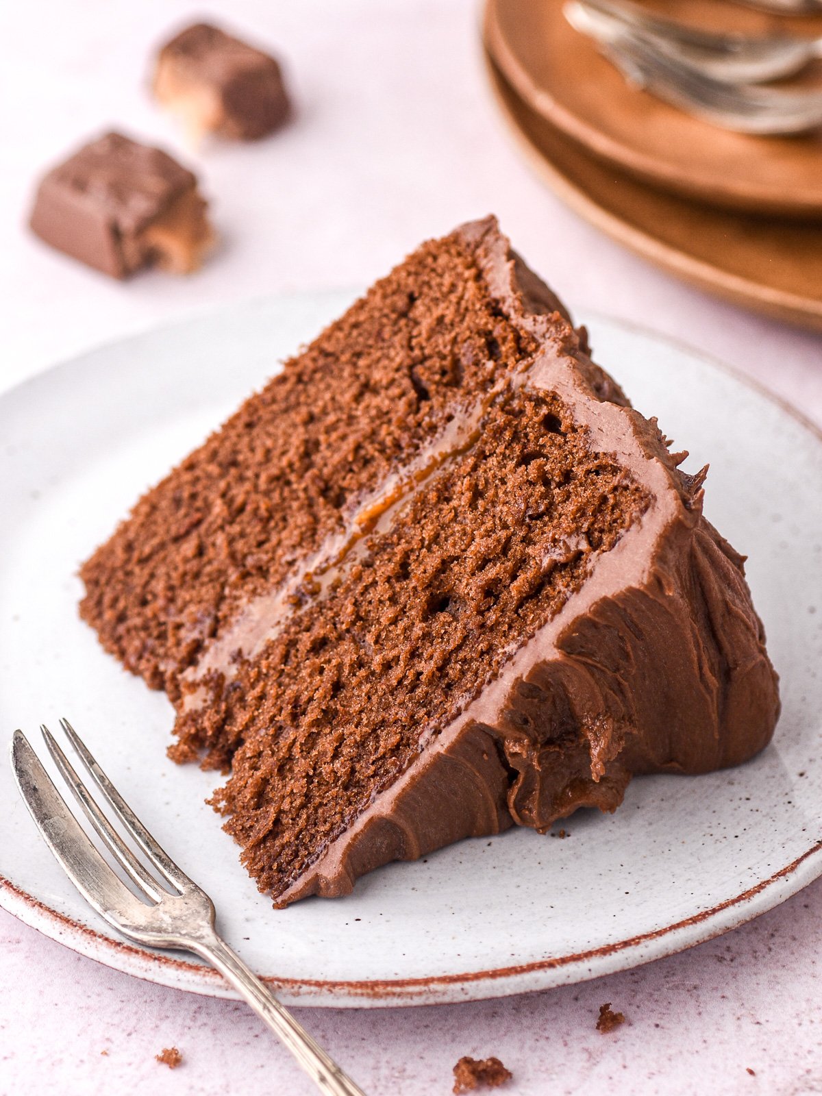 Image showing a slice of Bar One cake, you can see the caramel centre.