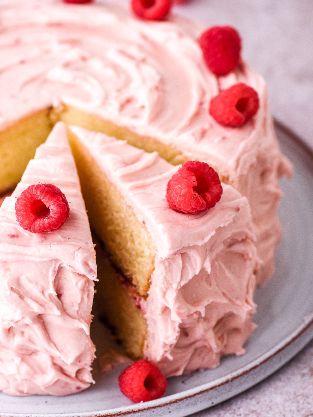 Image showing a whole raspberry cake with slices cut.