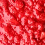 Image showing the strawberry filling up close. You can still see the whole strawberries in a vibrant red sauce.