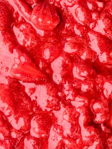 Image showing the strawberry filling up close. You can still see the whole strawberries in a vibrant red sauce.