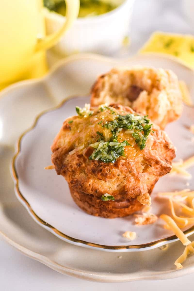 Image showing a muffin on a white and gold plate, the muffin has been topped with the parsley oil. 