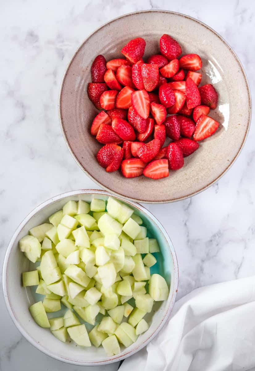 Image showing step 1 of how to make an Apple and Strawberry Crumble. 