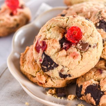 Cherry Chocolate Chip Cookies shown piled on a fluted plate.