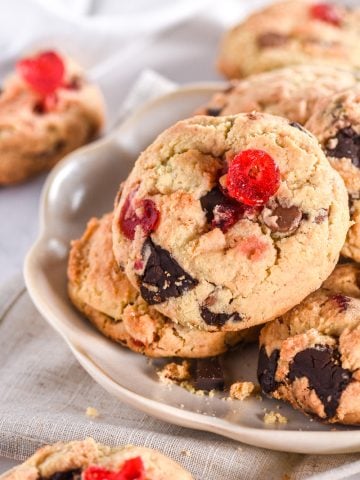 Cherry Chocolate Chip Cookies shown piled on a fluted plate.