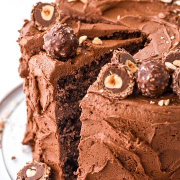 Image showing the whole cake on a cake plate, a slice has been cut.