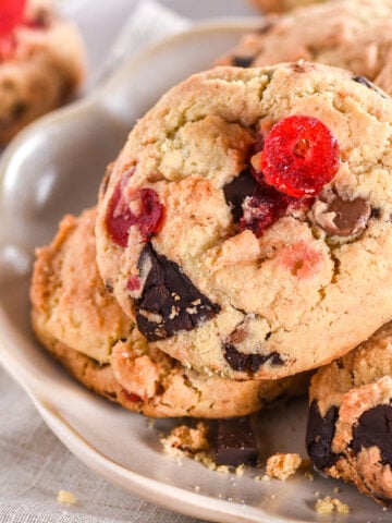 A pile of cookies shown on a fluted plate.