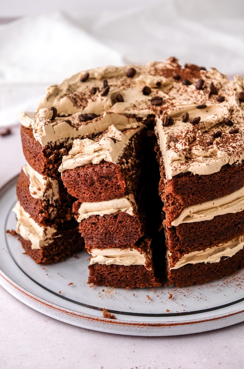 Espresso Martini Birthday Cake shown sliced on a cake plate. 