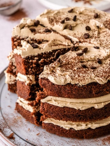 Image showing the espresso martini cake on a plate, some slices have been cut.