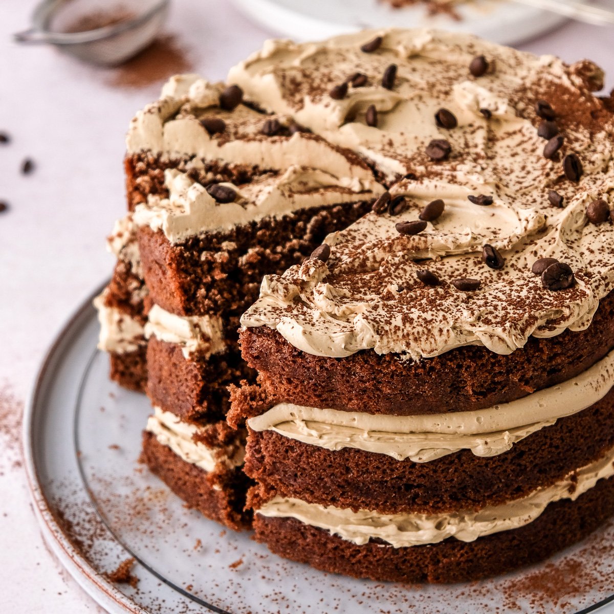 Image showing the espresso martini cake on a plate, some slices have been cut.