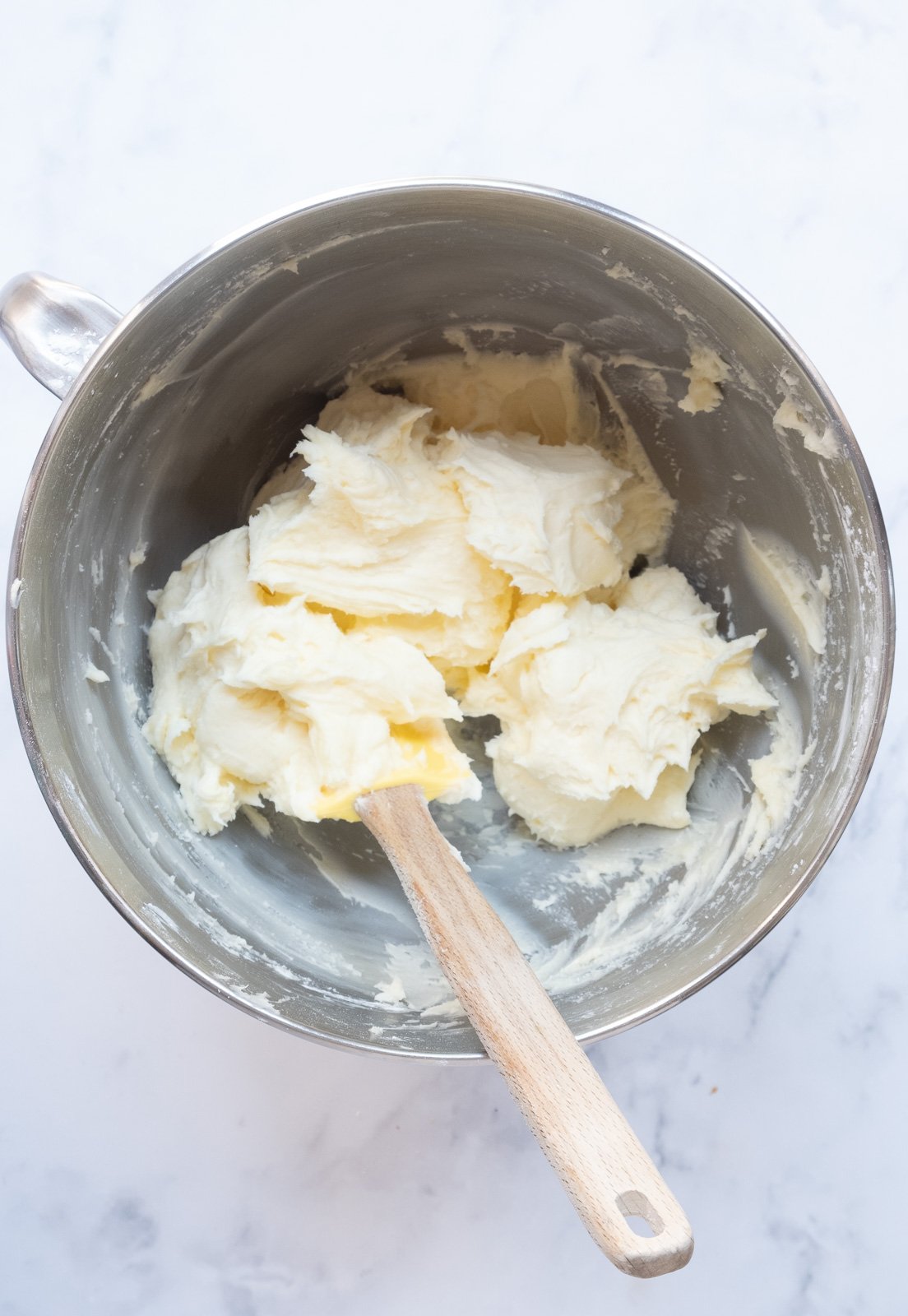 Image shows step 2 of how to make the cream cheese frosting.