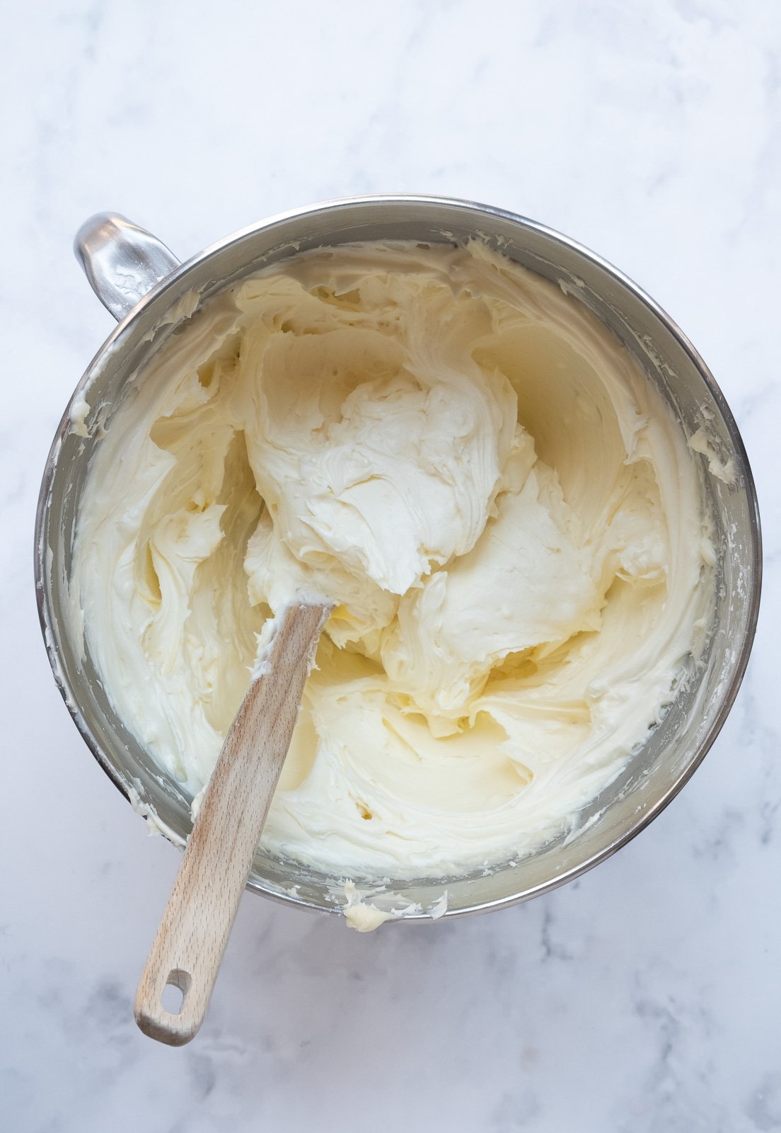 Image shows step 3 of how to make the cream cheese frosting.