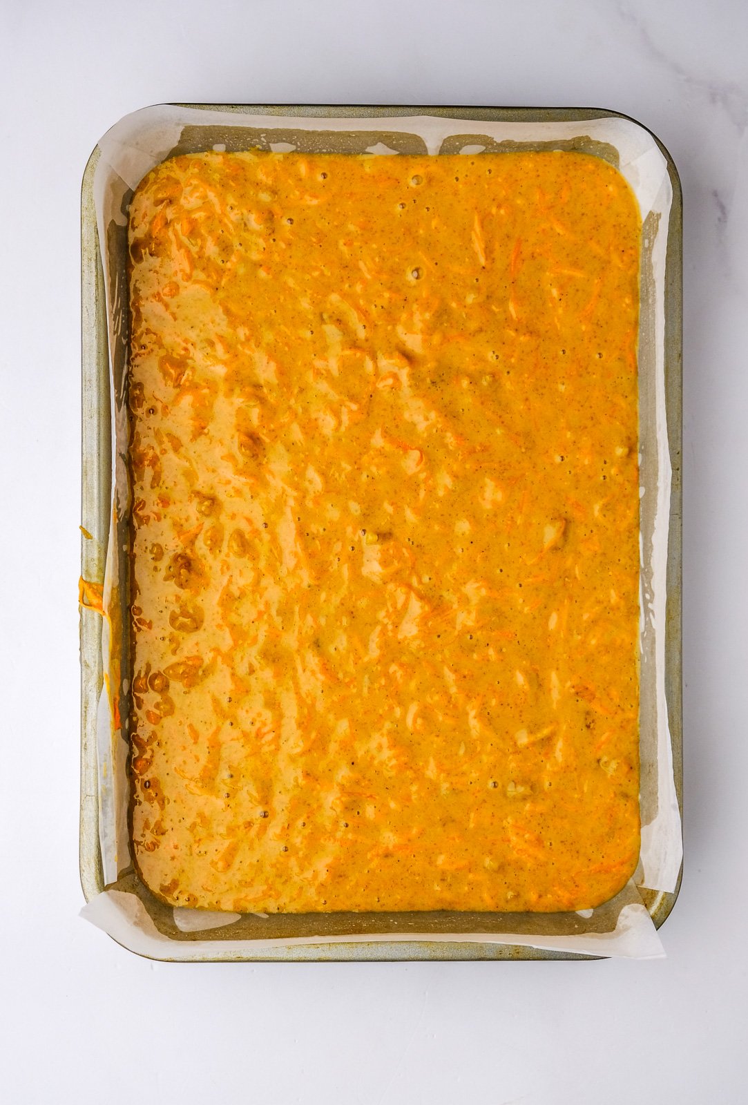 Image shows step 4 of how to make the carrot cake.