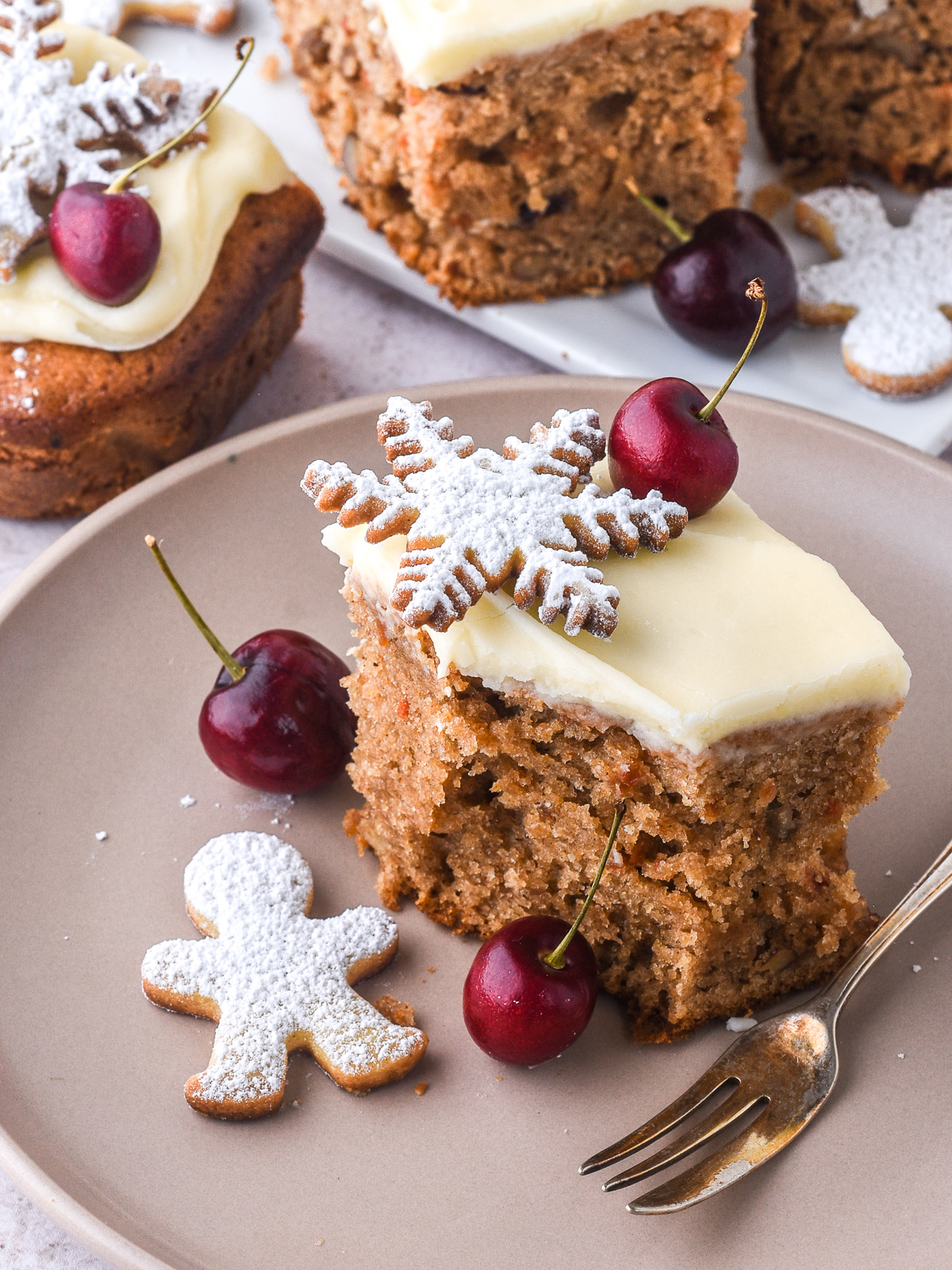 Christmas Carrot Sheet Cake slice shown on a plate, there is a bite missing.
