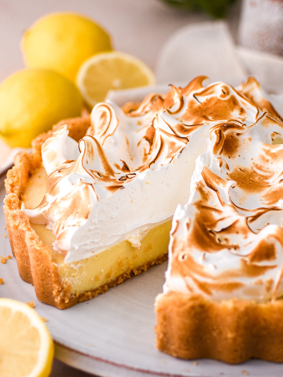 Image showing a lemon meringue pie with. a slice missing.