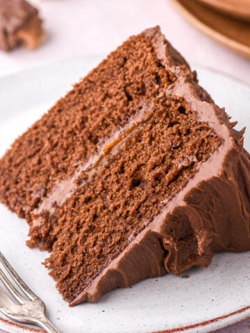 A slice of Bar One Chocolate caramel Cake show on a plate, it looks perfect.