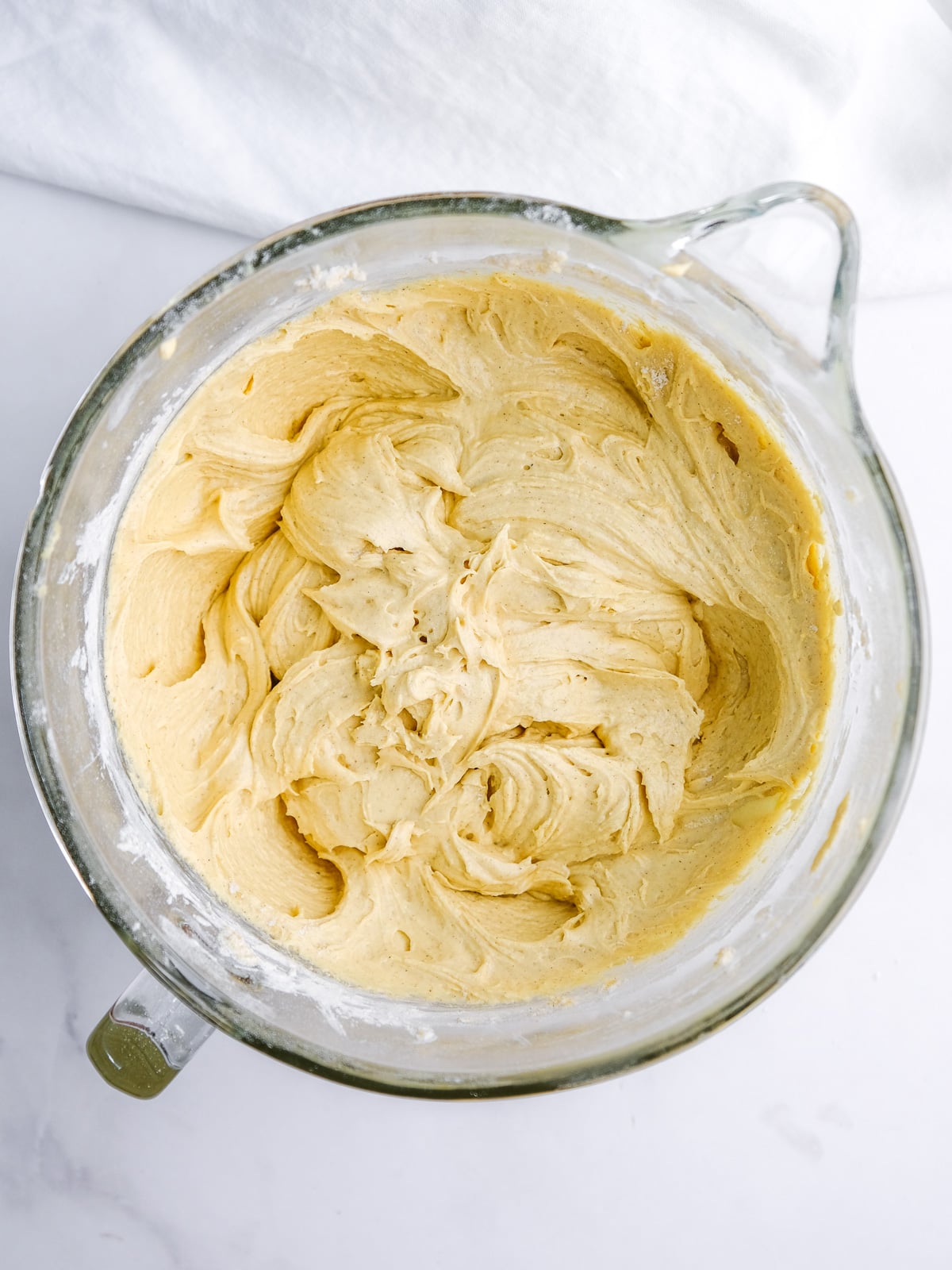 Image shows step 5 of how to make an apple and pecan cake: add sour cream and dry ingredients.
