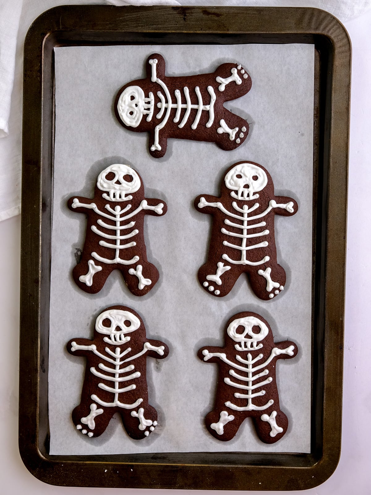 Image shows step 4 of placing the decorated cookies back onto a tray for the oven.