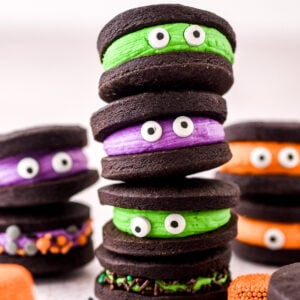 Chocolate Halloween Monster Cookie Sandwiches shown stacked on top of one another.