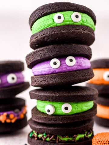 Chocolate Halloween Monster Cookie Sandwiches shown stacked on top of one another.