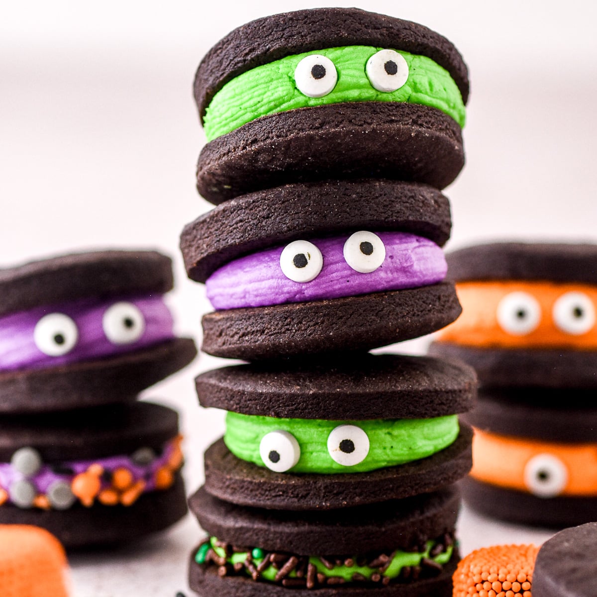 Chocolate Halloween Monster Cookie Sandwiches shown stacked on top of one another.